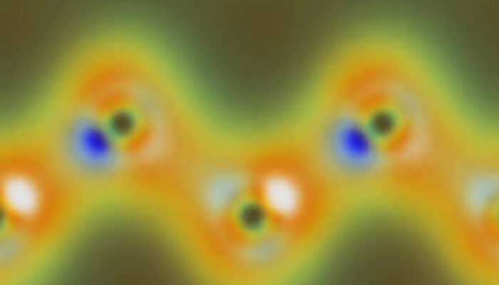 What happen at an atomic scale when light is reflected?